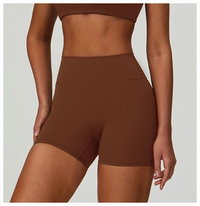 Detail view of high-waisted chocolate brown yoga shorts with seamless contouring fit