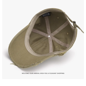 Detail of army green distressed cotton baseball cap showing interior wash label and fabric