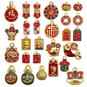 Macro shot of gold enamel pendants featuring traditional Chinese New Year lion and fortune motifs
