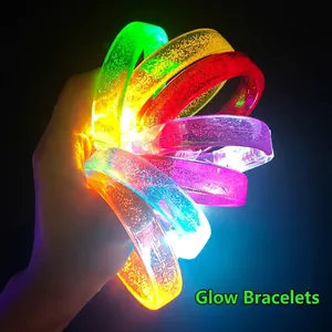 Five colorful LED bubble bracelets in red green orange pink blue glowing on black background