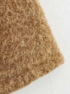 Macro shot of brown mohair vest showing soft fluffy fiber texture and high quality knit