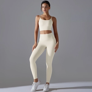Detailed close-up of cream white high-stretch yoga set with cross-back sports bra and leggings