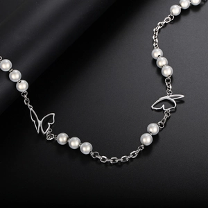 Detailed shot of titanium steel butterfly links and reflective pearls on a hip hop necklace