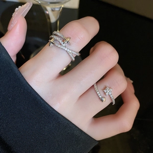 Detailed macro view of silver star rings with zircon inlay on a model's hand