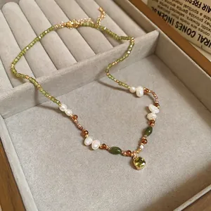18k gold-plated pearl necklace featuring green gemstone pendant and peridot beads
