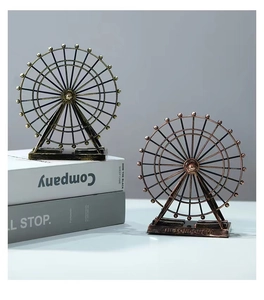Close-up of vintage bronze and copper metal Ferris wheel models with London Eye engraving