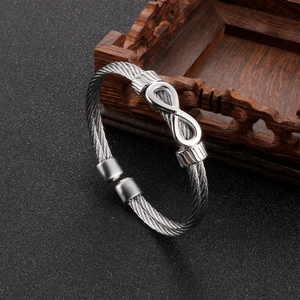 Detailed view of the silver infinity knot and woven steel wire cable cuff bracelet