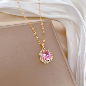Macro shot of pink oval gemstone necklace with diamond halo on champagne silk background