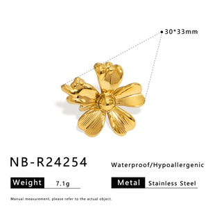 Macro detail of golden flower ring showing textured stainless steel petals and structure