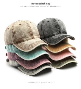 Close-up of vintage washed denim baseball caps showing multiple colors and aged texture