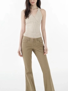 Close-up of beige knit halter top with V-neck cross design and ribbed texture