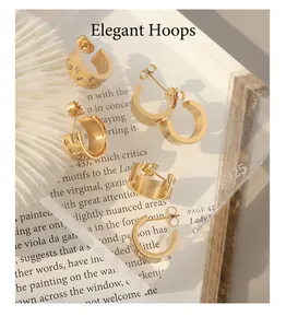 Detailed view of three pairs of C-shaped gold-plated stainless steel earrings with zircon