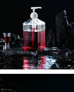 Detailed view of 1100ml glass syrup bottle with capacity scale and white pump head
