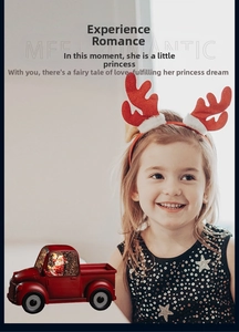 Macro detail of red vintage Christmas truck music box with Santa Claus and glitter snow
