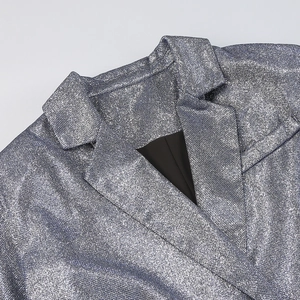 Detailed close-up of silver sequin glitter blazer fabric with sharp notch lapel design