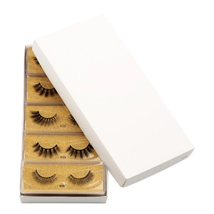 Detailed view of 5 pairs of 3D faux mink eyelashes in box with gold glitter base