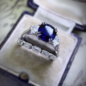 Elegant silver alloy ring set featuring a large blue zircon stone in a velvet gift box