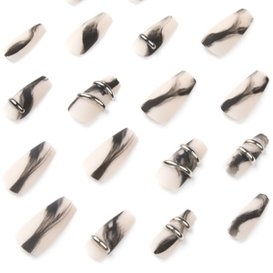 Matte black marble press-on nails with silver metal ring accents in long coffin shape