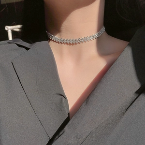 Three-row rhinestone choker necklace in silver finish worn on model with elegant side view