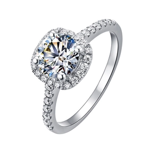 Macro shot of silver halo ring with round solitaire diamond and paved band detail