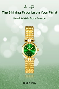 Detail of green sunray dial and gold beaded bracelet on luxury women watch