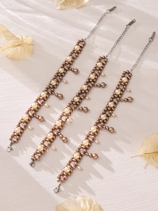Detail of vintage cream and bronze pearl tassel bracelets with S.Steel lobster clasps