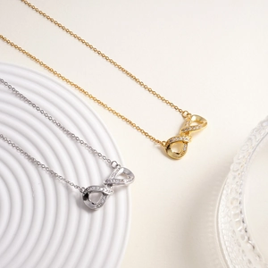 Elegant infinity pendant necklaces in gold and silver finish with sparkling zirconia stones