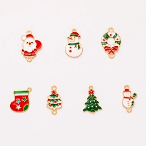 Set of 7 colorful Christmas enamel charms including Santa, snowman, and tree on white background