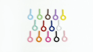 Close-up of assorted colorful eye pin screws for DIY jewelry making and keychains