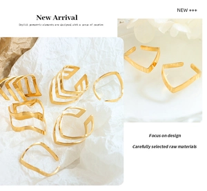 Detailed view of rose gold V-shaped and wavy open rings with a polished geometric finish