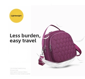 Detail view of purple waterproof nylon bag with quilted texture and metal zippers