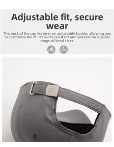 Detail of adjustable silver metal buckle and breathable laser-cut holes on gray baseball cap