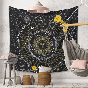 Detail of bohemian mandala tapestry featuring celestial sun and moon motifs in a cozy room