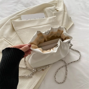 Chic pleated cloud bag in off-white with silver chain strap and magnetic closure