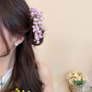 Elegant purple flower hair pin accessory for sophisticated wedding updos on brunette hair