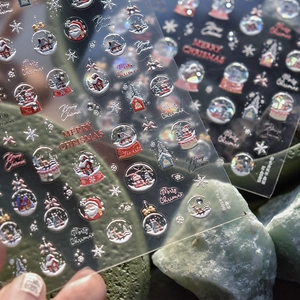 Detailed view of 5D embossed Christmas nail stickers with Santa and snowflake patterns
