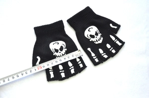 Detailed view of black knitted fingerless gloves with white luminous skeleton hand print