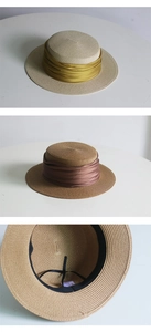 Detail of vintage straw boater hats with satin ribbons and adjustable inner sweatbands