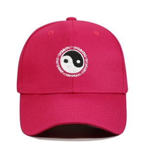 Detail of Yin Yang embroidery and Swimming text on pink cotton baseball cap