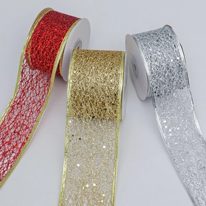 Detail of red, gold, and silver glitter mesh ribbons for Christmas gift wrapping and bows