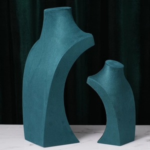 Dark green velvet necklace display bust set for jewelry presentation on marble base