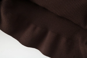Close-up of the ribbed hem and high-density knit texture on this dark brown sweater