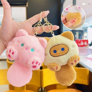 Plush cat keychains in pink and beige with internal squeaker and golden metal clips