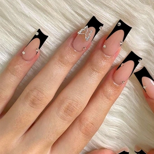 Long trapezoid press-on nails with black French tips and crystal butterfly accents