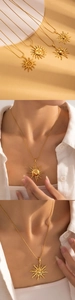 Gros plan d'un collier avec pendentif soleil doré, finition polie et chaîne à maillons fins
