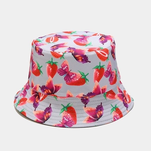Detail view of foldable sun hat with strawberry and butterfly patterns on canvas fabric