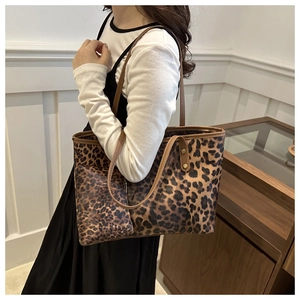 Leopard print tote bag and matching mini pouch shown on model in a minimalist setting