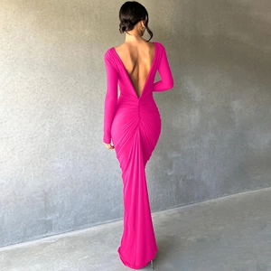 Detail view of the backless deep V-neckline and ruched waist of the rose red maxi dress