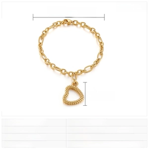 Detail view of a gold-plated stainless steel hollow heart pendant on a woven link chain