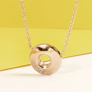 Detailed close-up of rose gold necklace featuring My Love engraving and sparkling zircon
